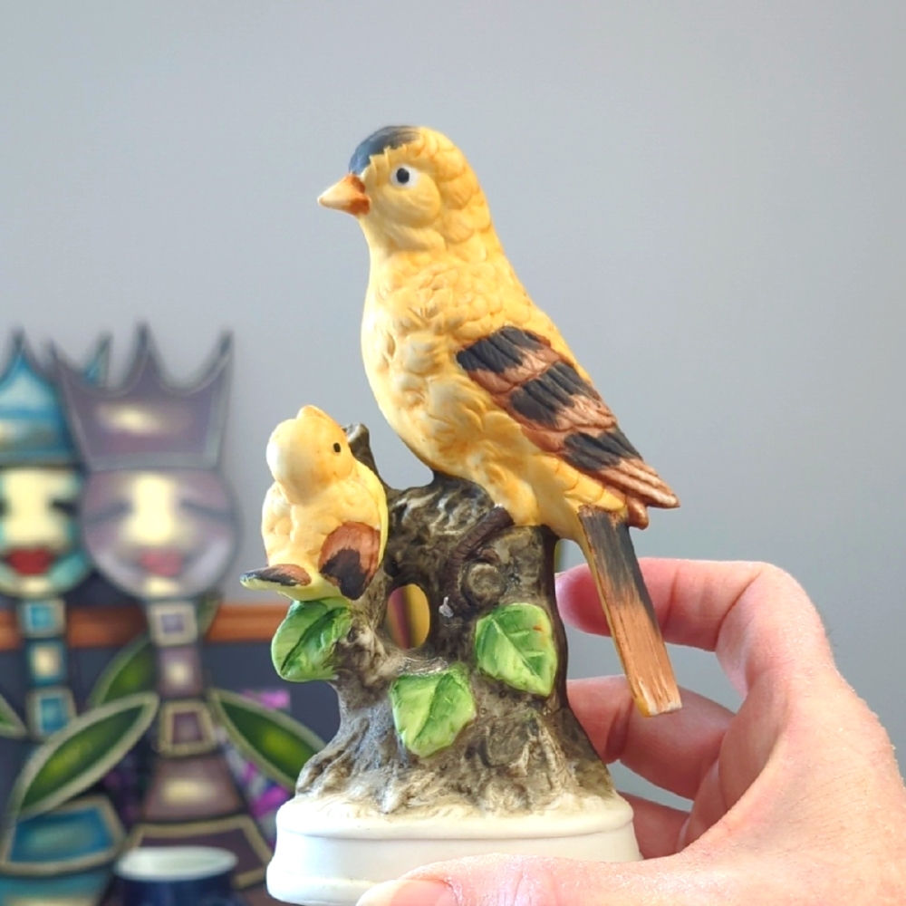 vintage porcelain figurine of two yellow goldfinch birds perched on a branch